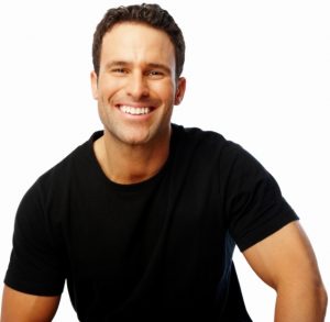 A handsome man smiling against white background