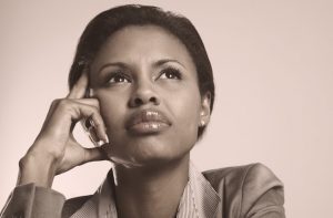 Young African American business woman looking away in a thought against a background