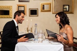 Couple examining menus in restaurant